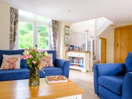 A living room with seating and a coffee table at Gelli Barn near Llandeilo