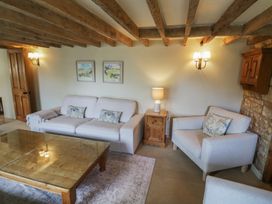 A living room with a sofa and coffee table at Robins Nest in Bourton-On-The-Water