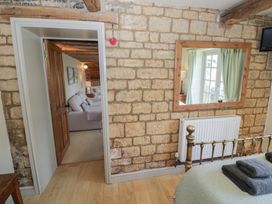 A bedroom with a door and window at Robins Nest in Bourton-On-The-Water