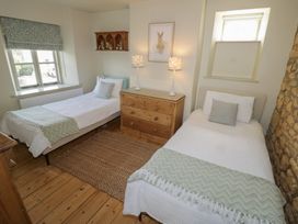 A bedroom with two beds and a dresser at Robins Nest in Bourton-On-The-Water