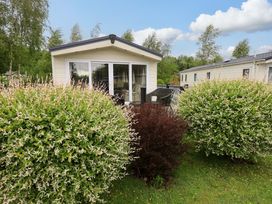 A cabin with large bushes in the outdoor area at 41, Grandma's Cottage South Lakeland Leisure Village near Carnforth