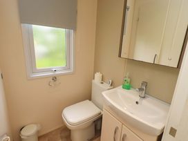A bathroom with a toilet and wash basin at 41, Grandma's Cottage South Lakeland Leisure Village near Carnforth