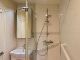 A bathroom with a shower and sink at 41, Grandma's Cottage near South Lakeland Leisure Village near Carnforth