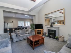 A living room with a sofa, coffee table, and television at Clarence House in Dalton-In-Furness