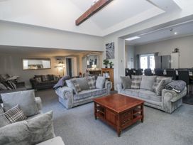 A living room with a sofa set and dining area at Clarence House in Dalton-In-Furness