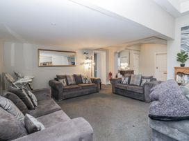 A living room with sofas and a mirror at Clarence House in Dalton-In-Furness