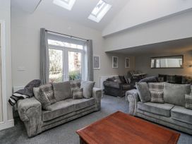 A living room with sofas and a coffee table at Clarence House in Dalton-In-Furness