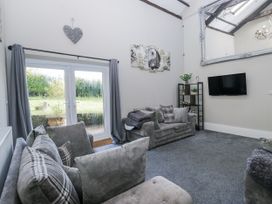 A living room with a sofa and television at Clarence House in Dalton-In-Furness