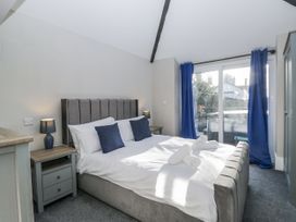 A bedroom with a bed and bedside table at Clarence House in Dalton-In-Furness