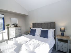 A bedroom with a bed, bedside tables and lamps at Clarence House in Dalton-In-Furness