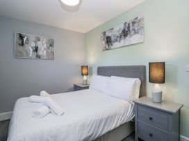 A bedroom with a bed and bedside tables at Clarence House in Dalton-In-Furness