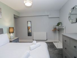 A bedroom with a bed and a mirror at Clarence House in Dalton-In-Furness