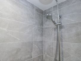 A shower with wall tiles at Clarence House in Dalton-In-Furness