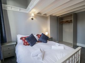 A bedroom with a bed and a wardrobe at Clarence House Dalton-In-Furness