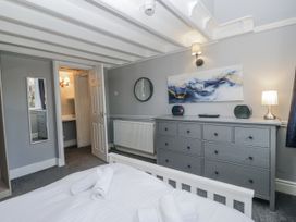 A bedroom with a bed and dresser at Clarence House in Dalton-In-Furness