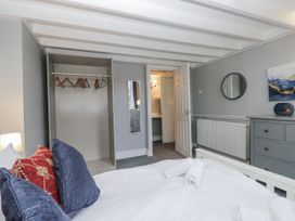 A bedroom with a bed and wardrobe at Clarence House Dalton-In-Furness