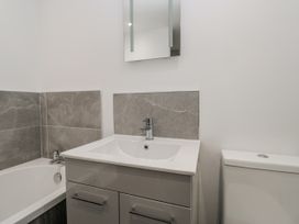 A bathroom with a bathtub and sink at Clarence House Dalton-In-Furness