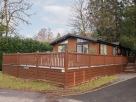 A lodge with a wooden deck and railings at Unique Luxury Lodge 1 Langdale, White Cross Bay near Windermere