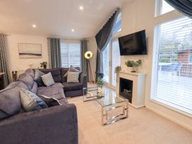 A living room with a sofa and coffee table at Unique Luxury Lodge, 1 Langdale, White Cross Bay near Windermere
