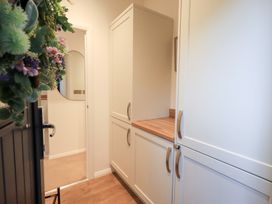 A hallway with cabinets and a mirror at Unique Luxury Lodge, 1 Langdale, White Cross Bay near Windermere