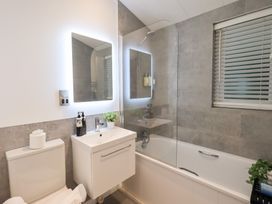 A bathroom with a sink, toilet, and bathtub at Unique Luxury Lodge, 1 Langdale, White Cross Bay near Windermere