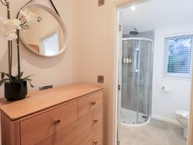 A bathroom with a shower and toilet at Unique Luxury Lodge 1 Langdale, White Cross Bay near Windermere