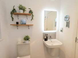 A bathroom with a sink and a toilet at Unique Luxury Lodge, 1 Langdale, White Cross Bay near Windermere