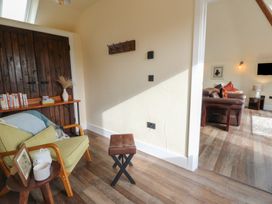 A snug with wooden doors and furniture at Ty Crwn Lampeter