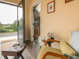 An entrance with a chair and door at Ty Crwn in Lampeter