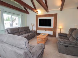A living room with a sofa and a television at Whitbarrow 24 in Penruddock
