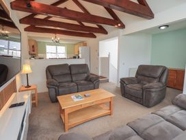 A living room with a sofa and armchairs at Whitbarrow 24 in Penruddock