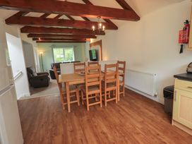 A dining room with a table and chairs at Whitbarrow 24 in Penruddock