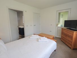 A bedroom with a bed and television at Whitbarrow 24 in Penruddock