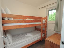 A bedroom with a bunk bed and a window at Whitbarrow 24 in Penruddock