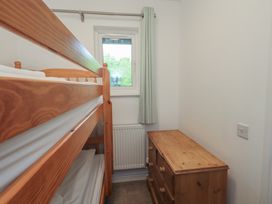 A bedroom with a bunk bed and a dresser at Whitbarrow 24 in Penruddock