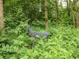 A wire sculpture of a deer among plants in a forest at The Leveret in Eppleby