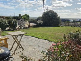 A garden with a table and grill at Freefolk Cottage in Polzeath