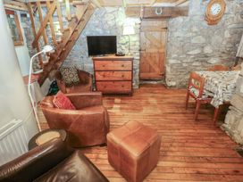 A living room with a television and a chest of drawers at Penfeidr Newydd, Carningli Common, Newport, Pembrokeshire