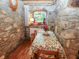 A dining room with a table and chairs at Penfeidr Newydd, Carningli Common, Newport, Pembrokeshire