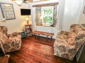A living room with a sofa and a recliner chair at Penfeidr Newydd in Carningli Common, Newport, Pembrokeshire