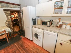 A kitchen with appliances including a refrigerator, washing machine, and dishwasher at Penfeidr Newydd, Carningli Common, Newport, Pembrokeshire