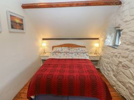 A bedroom with a bed and side tables at Penfeidr Newydd, Carningli Common, Newport, Pembrokeshire