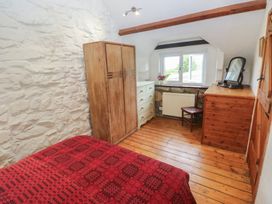 A bedroom with a bed and furniture at Penfeidr Newydd in Carningli Common, Newport, Pembrokeshire