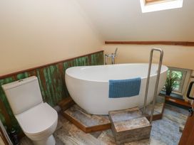 A bathroom with a bathtub and toilet at Penfeidr Newydd, Carningli Common, Newport, Pembrokeshire