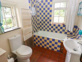 A bathroom with a bathtub, toilet, and sink at Penfeidr Newydd, Carningli Common, Newport, Pembrokeshire