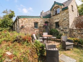 An outdoor seating area with a stone building at Penfeidr Newydd in Carningli Common, Newport, Pembrokeshire