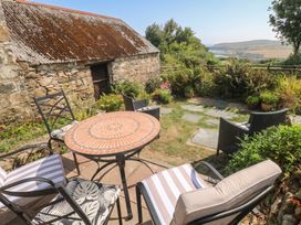 A garden with a table and chairs at Penfeidr Newydd, Carningli Common, Newport, Pembrokeshire