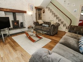 A living room with a fireplace and sofa at Glenside House in Carbis Bay