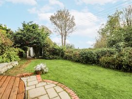 A garden with grass and plants at Glenside House in Carbis Bay
