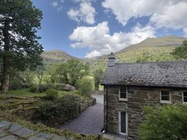 A house near mountains and trees at Glyn Awel Nant Gwynant near Beddgelert